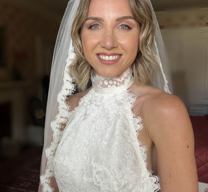 Bride wearing diamond tiara with a veil and a wedding dress